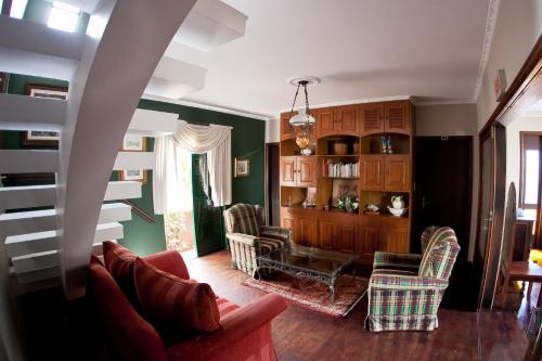 a living room with a couch and chairs at Quinta Da Bica D'Agua Village in Florianópolis