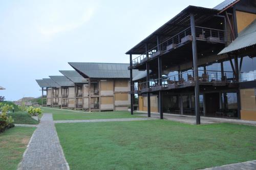 a large building with a lawn in front of it at Laya Safari Resorts & Spa in Yala