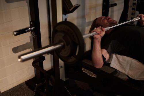 a man sitting in a gym lifting weights at hood house in Hamburg