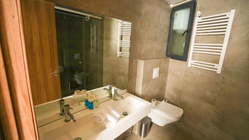 a bathroom with a sink and a toilet and a mirror at Sea View B16 - Mosqué Hassan II - By TheCasaEdition in Casablanca
