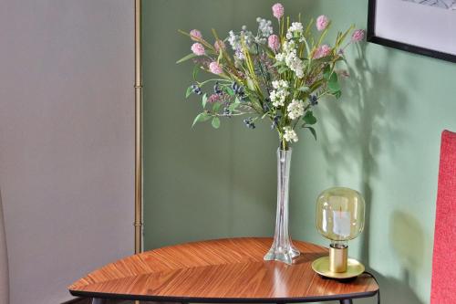 a vase of flowers sitting on top of a table at Appartements Cafe Schneider in Sankt Anton am Arlberg