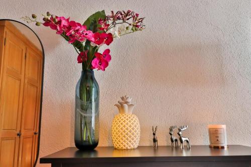 a vase with flowers in it sitting on a table at Appartements Cafe Schneider in Sankt Anton am Arlberg