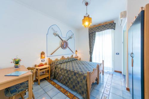 a bedroom with a bed and a table at Riviera B&B Rooms in Maiori