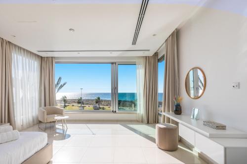 a living room with a view of the ocean at Beachfront Luxury Villa Glory in Ayia Napa