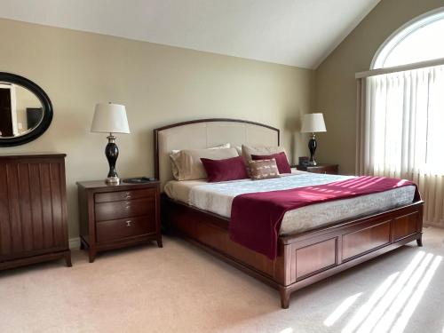 a bedroom with a large bed and two night stands at Hammer Haus in Waterloo