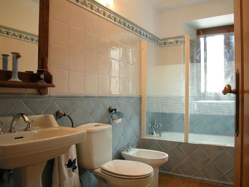 a bathroom with a toilet and a sink and a tub at Araiztar in Irañeta