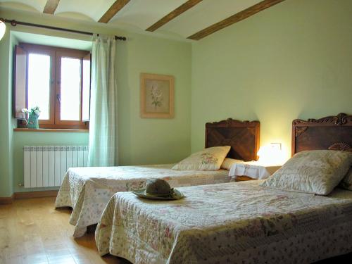 a bedroom with two beds with a hat on top of them at Araiztar in Irañeta