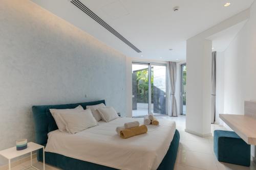 a bedroom with a bed with a teddy bear on it at Beachfront Luxury Villa Glory in Ayia Napa