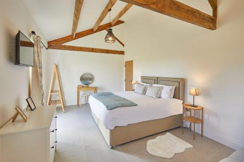 a bedroom with a bed and a dresser and a desk at Wold's View Cottage in Yedingham