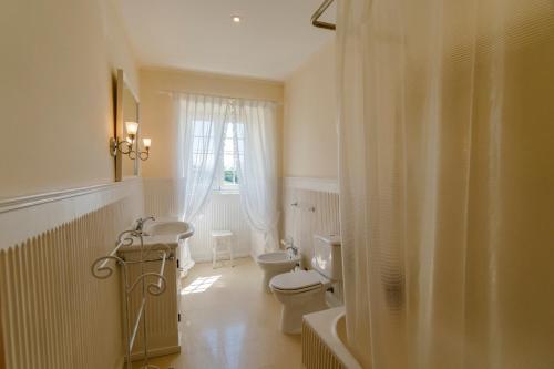 a bathroom with a sink and a toilet and a window at Monte Ingles in Ponta Delgada