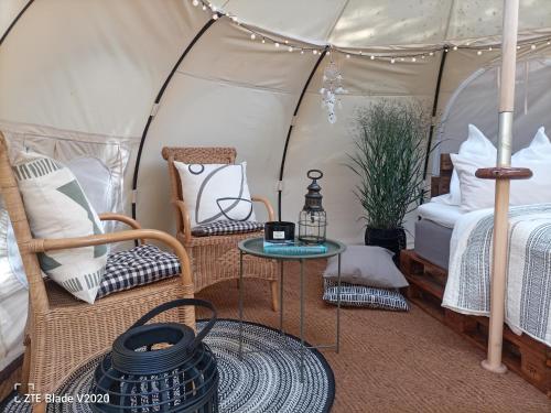 a room with a tent with a bed and a table at Glamping Altes Pastorat in Barmstedt