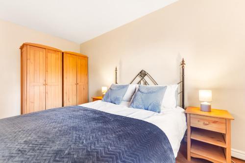 a bedroom with a large bed and a wooden cabinet at Call Lane in Leeds