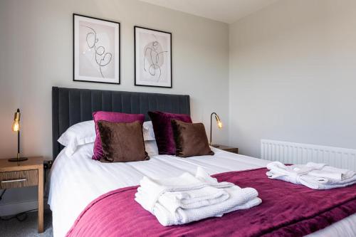 a bedroom with a bed with towels on it at The Sands Sea Front Apartments in Scarborough