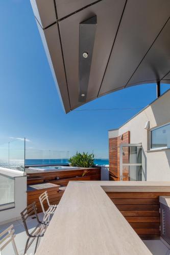 a kitchen with a view of the ocean at Beachfront Luxury Villa Glory in Ayia Napa