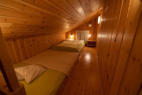 a room with three beds in a wooden cabin at Flotunet - Anestova in Stryn