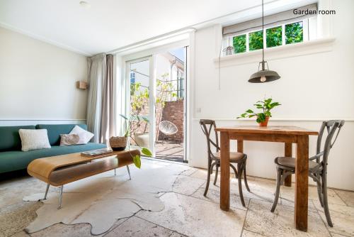 a living room with a table and a couch at Boutique hotel Villa Oldenhoff in Abcoude