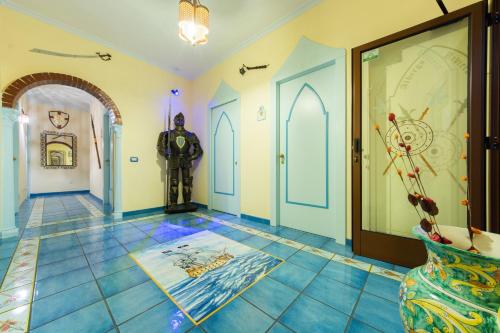 a room with a hallway with a man in a suit on the floor at Riviera B&B Rooms in Maiori