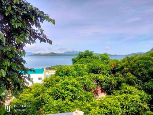 a view of the ocean from a hill with trees at Shared Room/ Dormitory Bed in Romblon Romblon in Romblon