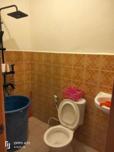 a bathroom with a toilet with a pink box on it at Shared Room/ Dormitory Bed in Romblon Romblon in Romblon