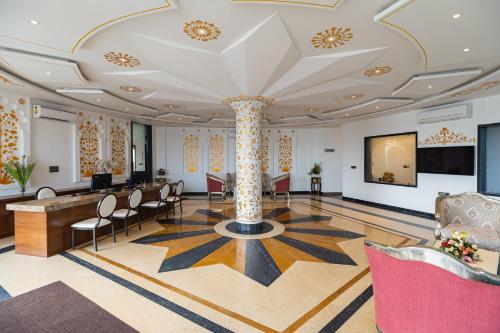a large room with a lobby with a column at Traavista Aravali Mahal - Luxury Lake View Heritage Resort in Udaipur in Udaipur