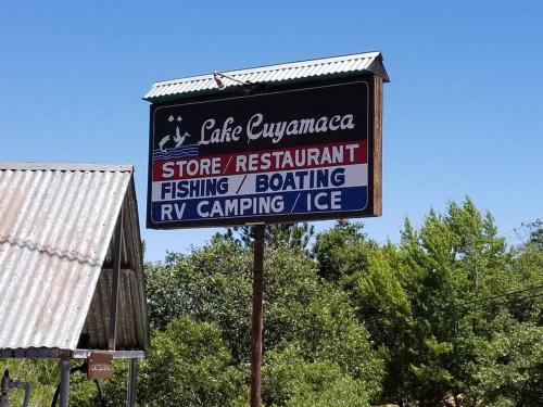 a sign for a store restart fishing and eating iv camping lodge at A LIVING CANVAS Amazing Lake View Custom Home in Julian