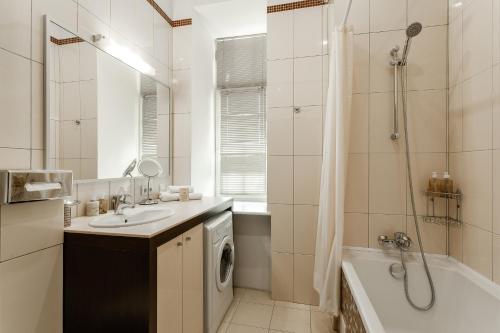 a bathroom with a sink and a washing machine at Senator Victory Square in Kyiv