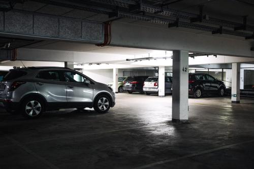 a parking garage with several cars parked in it at Ramada by Wyndham Essen in Essen