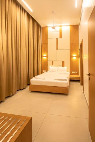a bedroom with two beds and a couch in it at RATHNA RESIDENCY - Near US CONSULATE in Chennai