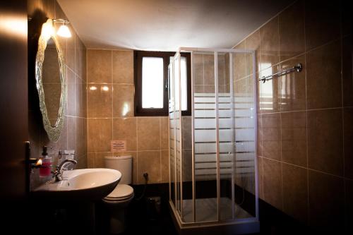 a bathroom with a shower and a toilet and a sink at Villa Evelyn in Stafylos