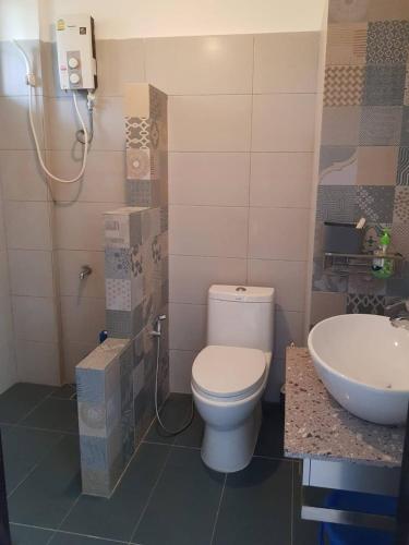 a bathroom with a toilet and a sink at Seaview Modern Studio in Sihanoukville
