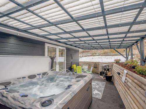 a large hot tub sitting inside of a house at Craigpark Lodge in Caldercruix