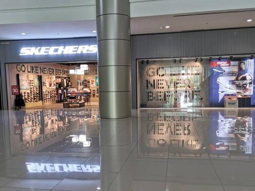 a shopping mall with glass windows and signs in it at Eko Studio@EVO SOHO BANGI with NETFLIX & WIFI in Kampong Sungai Ramal Dalam