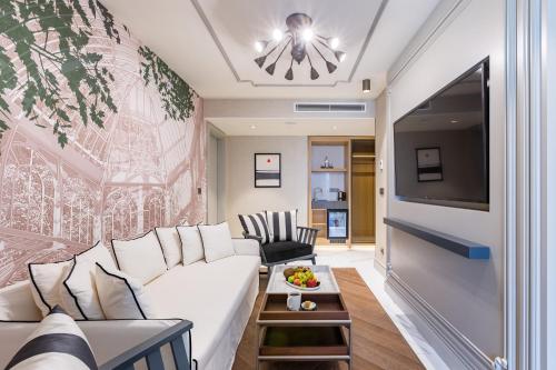 a living room with a white couch and a tv at Stayso The House Hotel in Istanbul
