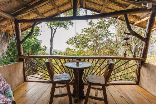 a table and two chairs on a porch at Sol de Minca Eco Lodge in Minca