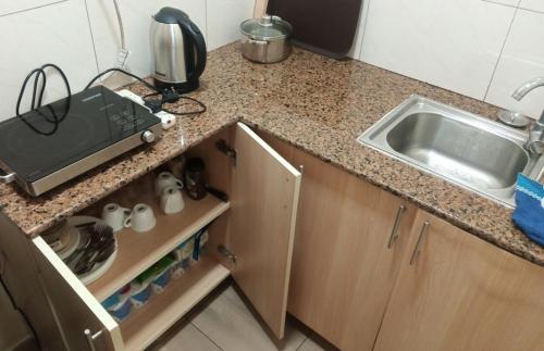 a kitchen with a sink and a counter top at Lake Lyantonde eco campsite original in Fort Portal
