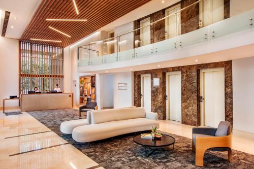 a lobby with a white couch and chairs at INNSiDE by Meliá São Paulo Iguatemi in Sao Paulo