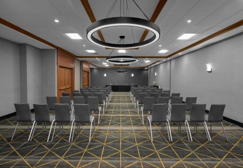 a conference room with chairs and a projection screen at Holiday Inn Hasbrouck Heights-Meadowlands by IHG in Hasbrouck Heights
