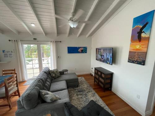 a living room with a couch and a table at Sound of The Sea-walking distance to everything in Placencia Village