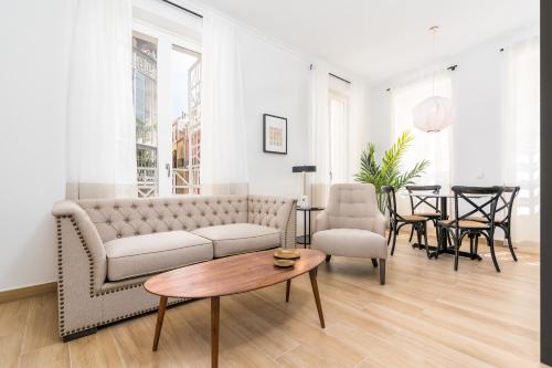 a living room with a couch and a table at iloftmalaga Santa María in Málaga