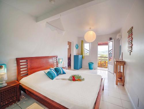 a bedroom with a large bed in a room at Habitation Bellevue in Sainte-Anne