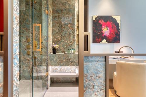 a bathroom with a shower and a sink at Grand Hotel Kalamata in Kalamata