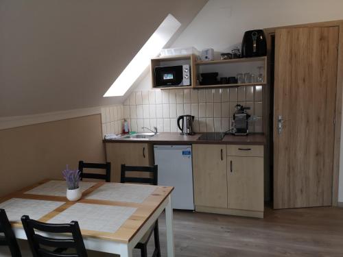 a kitchen with a table and a kitchen with a counter top at Villa Balifornia in Balatonboglár