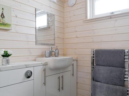 a bathroom with a sink and a mirror at The Den in Etteridge