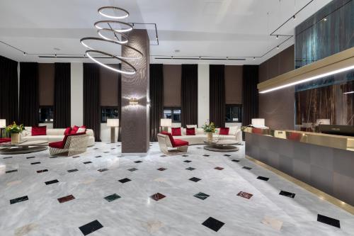 a lobby with chairs and a chandelier at Grand Hotel Kalamata in Kalamata