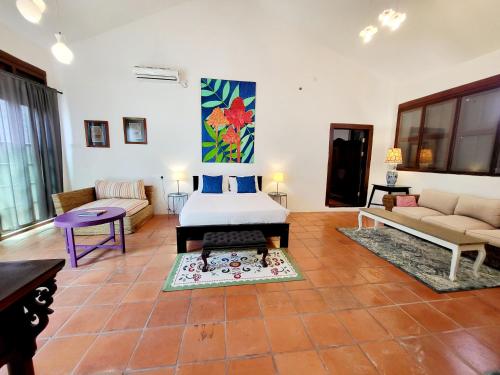 a living room with a bed and a couch at East Indies Mansion in George Town