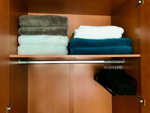 a closet with four towels and a pile of towels at At the heart of restaurants and night life in Mexico City