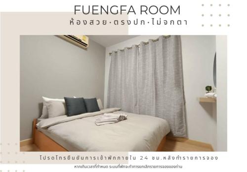 um quarto com uma cama com lençóis brancos e uma janela em Fuengfa Room em Khlong Luang