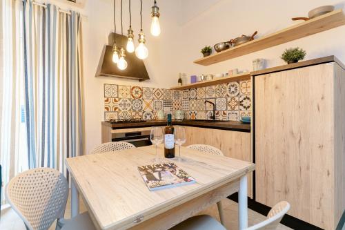 a kitchen with a wooden table and chairs at Latieri's Loft in Syracuse