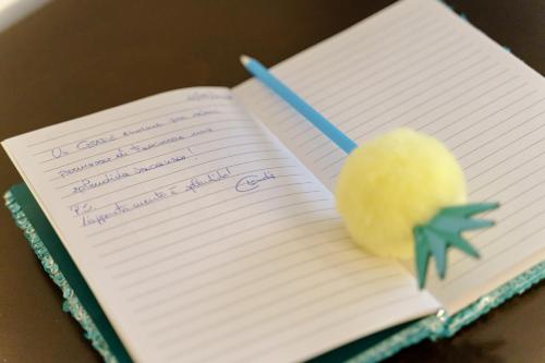 a spiral notebook with a ball and a pen on it at Latieri's Loft in Syracuse
