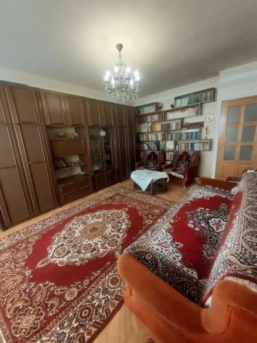 a living room with a couch and a chandelier at LA's Apartment with closed parking in Alaverdi